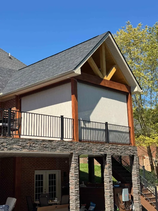 Elevated gable deck with a light screen lowered over the railing